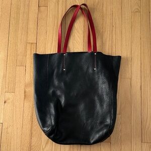 Roots pebbled black leather tote with red straps